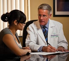 Image of David White, MD, with patient.